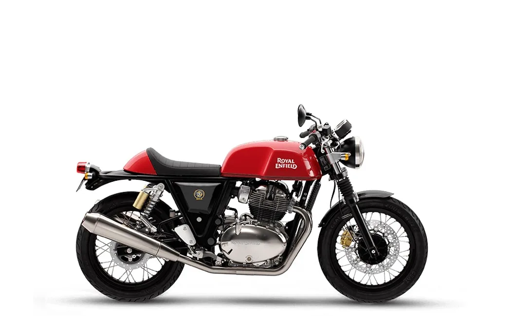 A side view of a Royal Enfield motorcycle in red, featuring a classic cafe racer design with a black seat and chrome details.